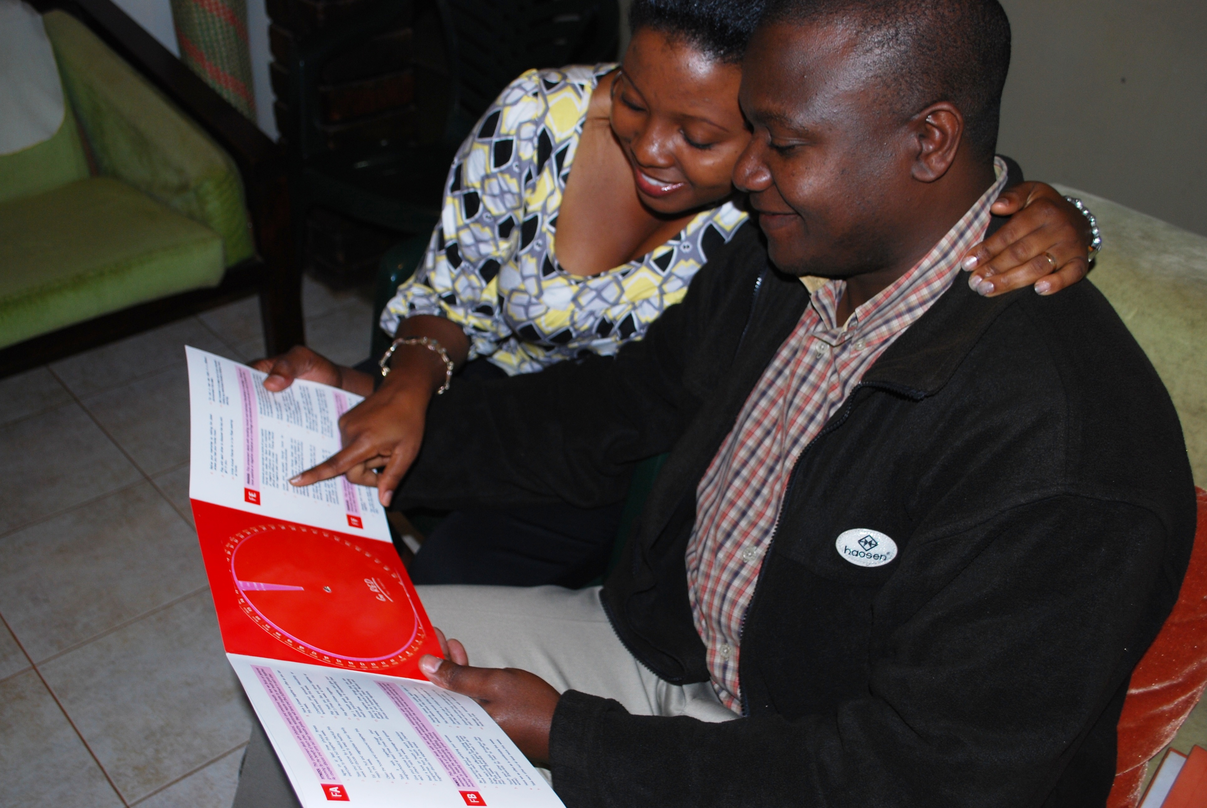 A couple looks at the love wheel, a tool to improve marriage and prevent HIV in Uganda