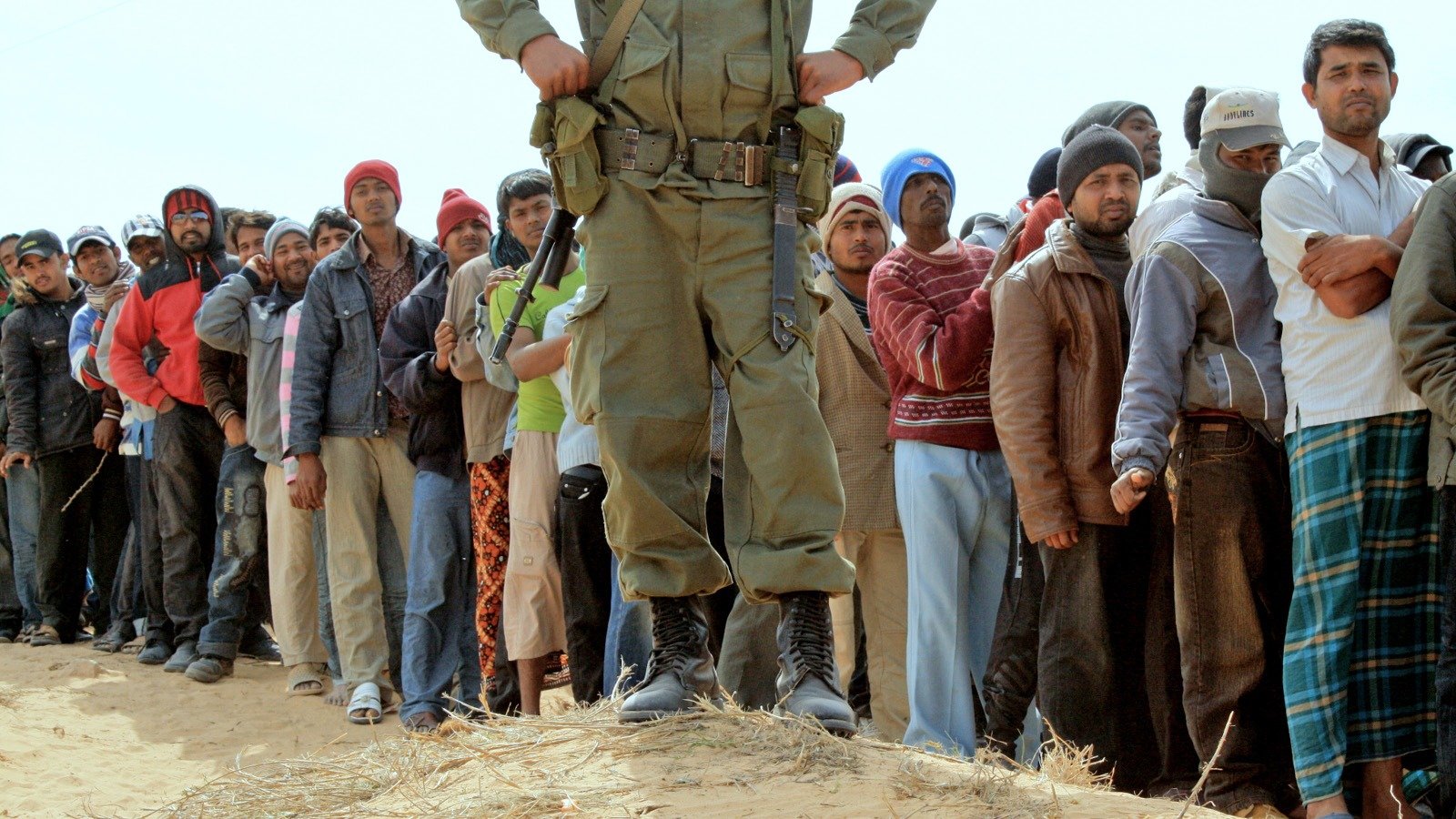 People line up for food at Choucha camp, at the Libya-Tunisia border