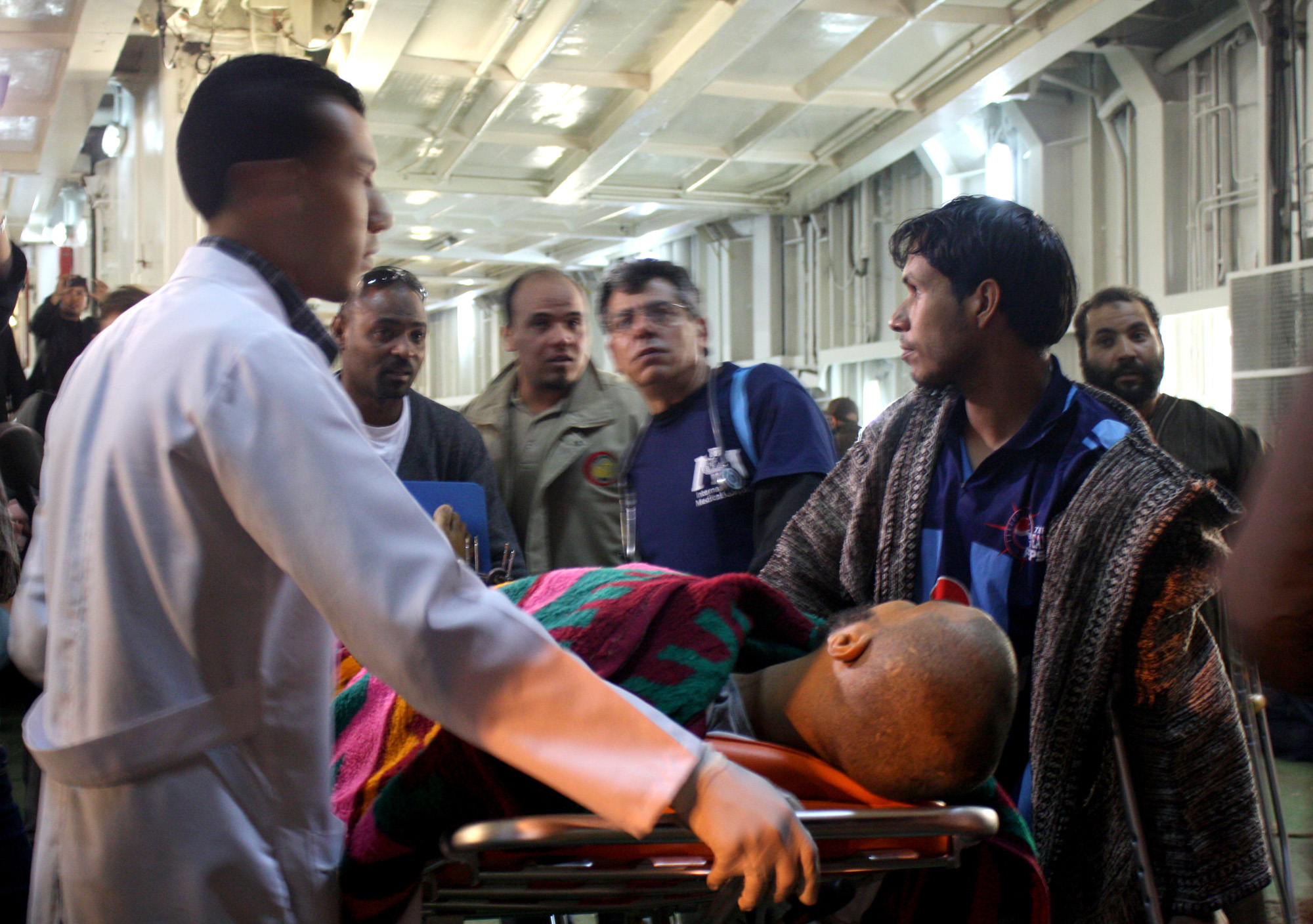 An injured man from Misrata is met by a team of paramedics and doctors from International Medical Corps after arriving in Benghazi on an IOM ship