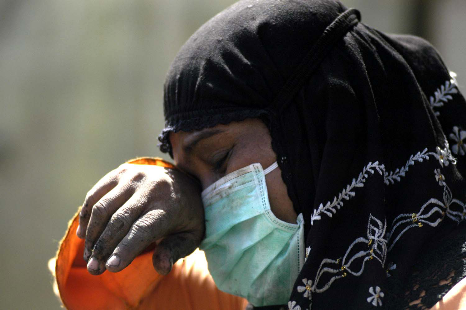A woman cries while searching for family members amidst the ruins of her collapsed home in Meulaboh, Aceh on 2 January, 2005. Meulaboh, the capital of West Aceh Regency, was one of the hardest hit areas