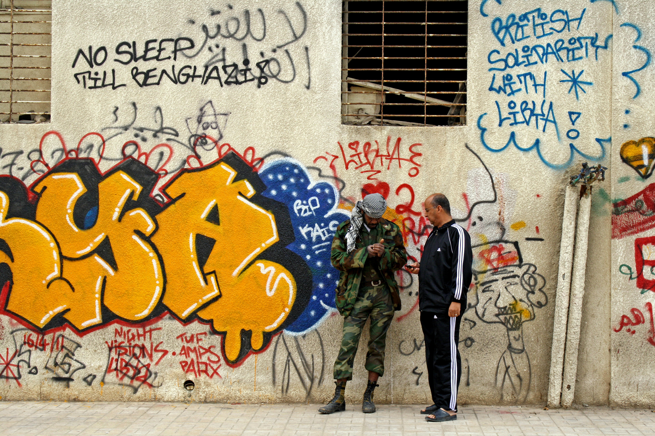 A rebel fighter chats to a friend in central Benghazi, a few metres from the Transitional National Council's headquarters