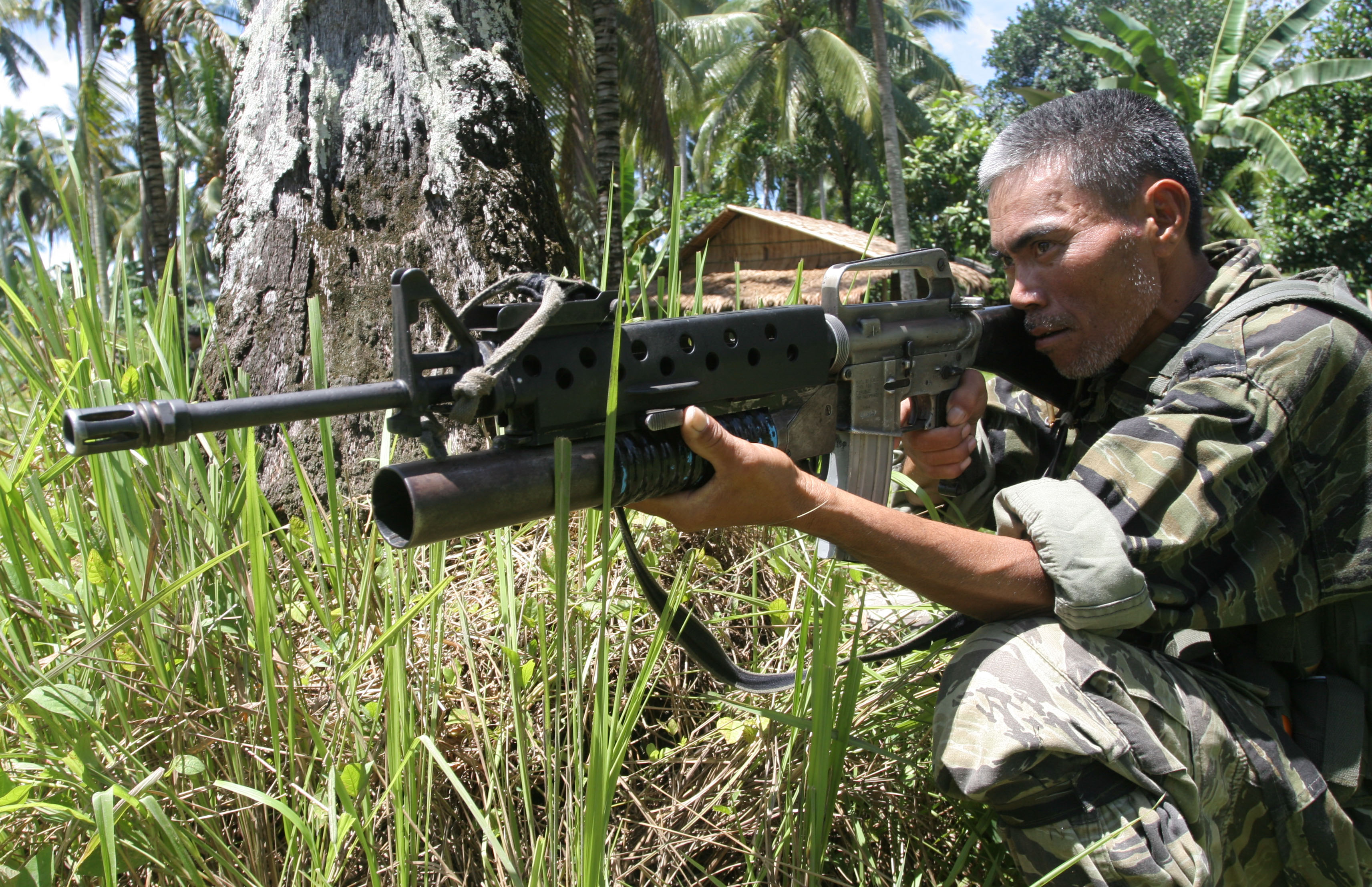 A Moro Islamic Liberation Front guerrilla guards a rebel encampment at Sultan Kudarat on the Philippine island of Mindanao