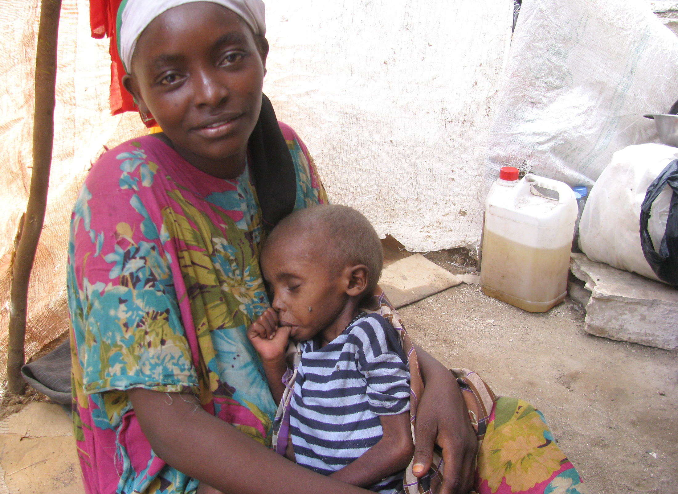 Three of Farhiya Osman Ahmed's five children died within a month due to drought and lack of healthcare. Ahmed, 28, holds one of the remaining children, who is very sick