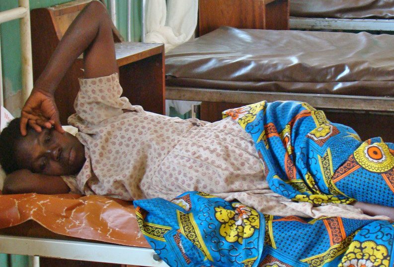 A mother awaits treatment at a health centre in Gulu, northern Uganda
