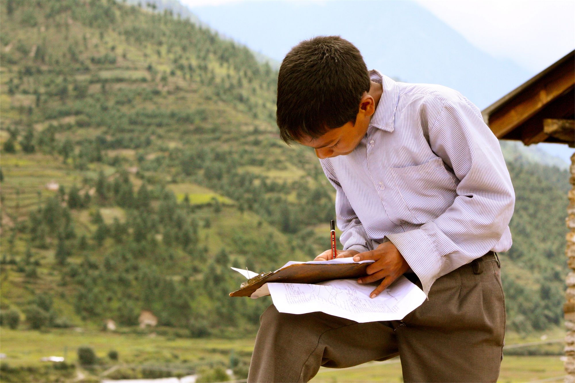 A young boy reading in Nepal. Some of the 15,000 children in Nepal's orphanages aren't even orphans