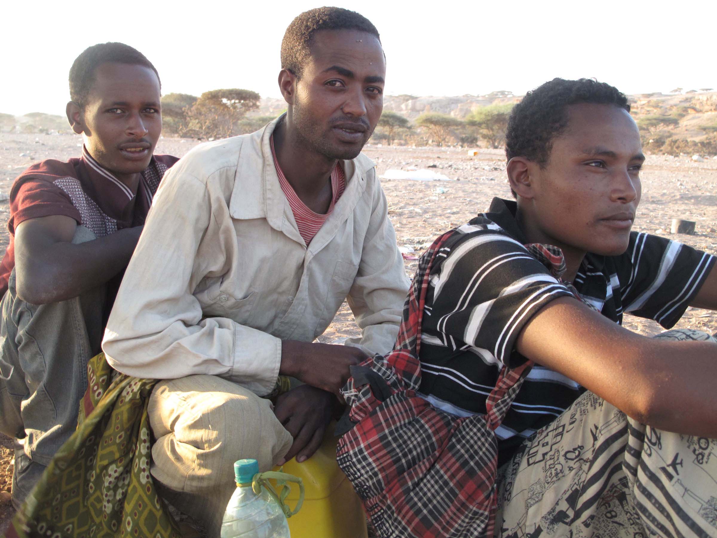 Osman Keno (pictured centre), a 21-year-old student from Ethiopia’s Oromia region, queues with other migrants being counted by their smuggler prior to transportation by boat from Obock to Yemen
