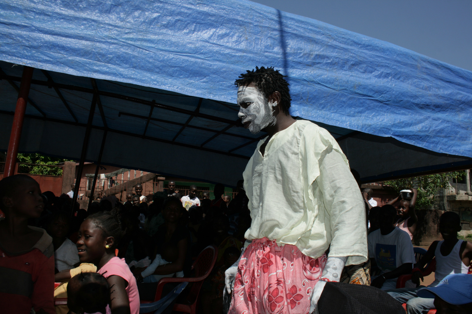 An actor, personifying cholera, tries to creep up on his victims