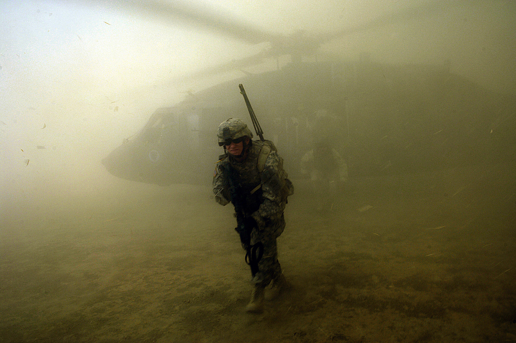 US Army soldiers exit a UH-60 Black Hawk during an aerial traffic control point mission near Tall Afar, Iraq