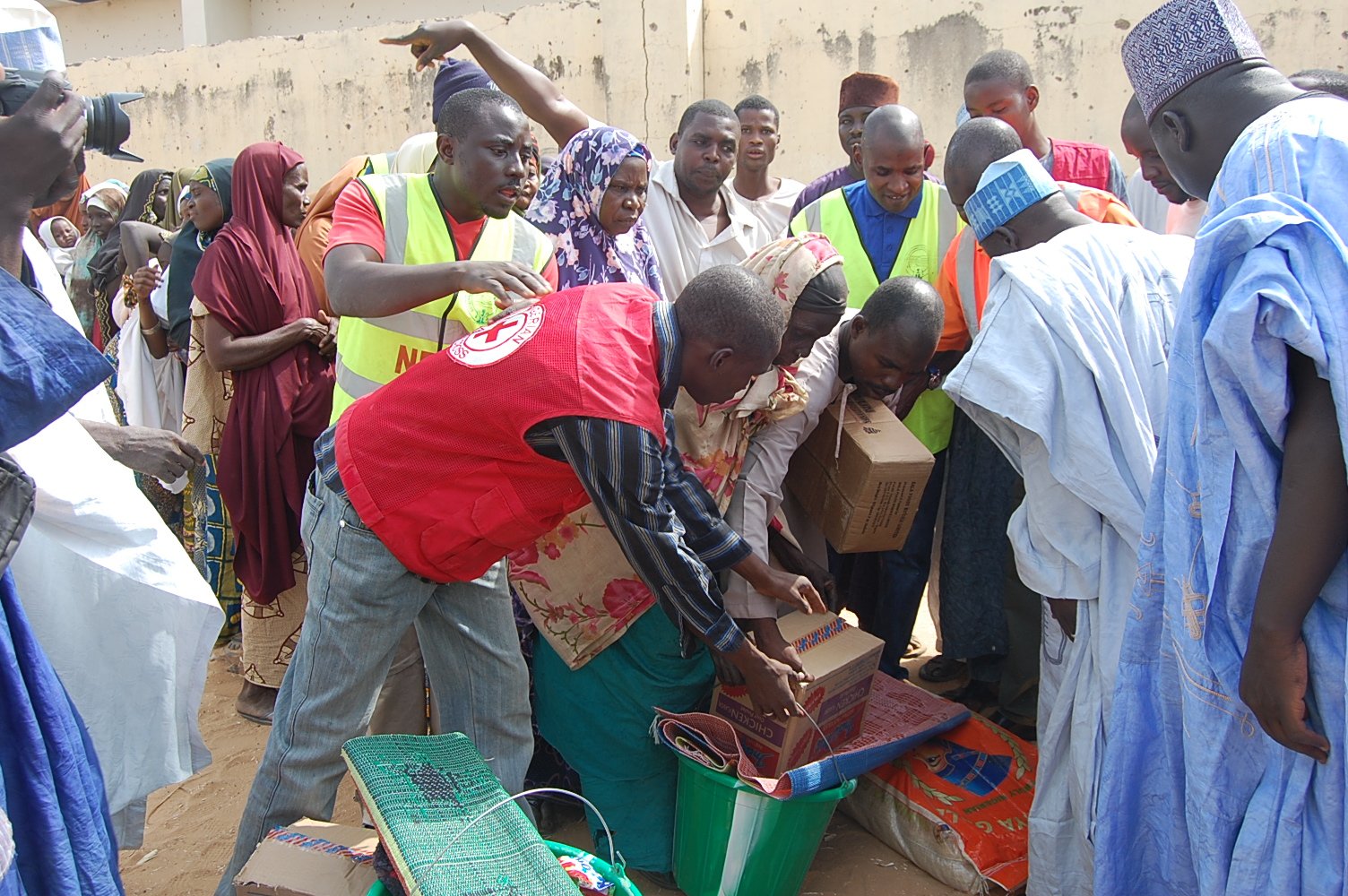 People displaced by Boko Haram attacks and the violence that ensued in Damaturu city, collect relief materials