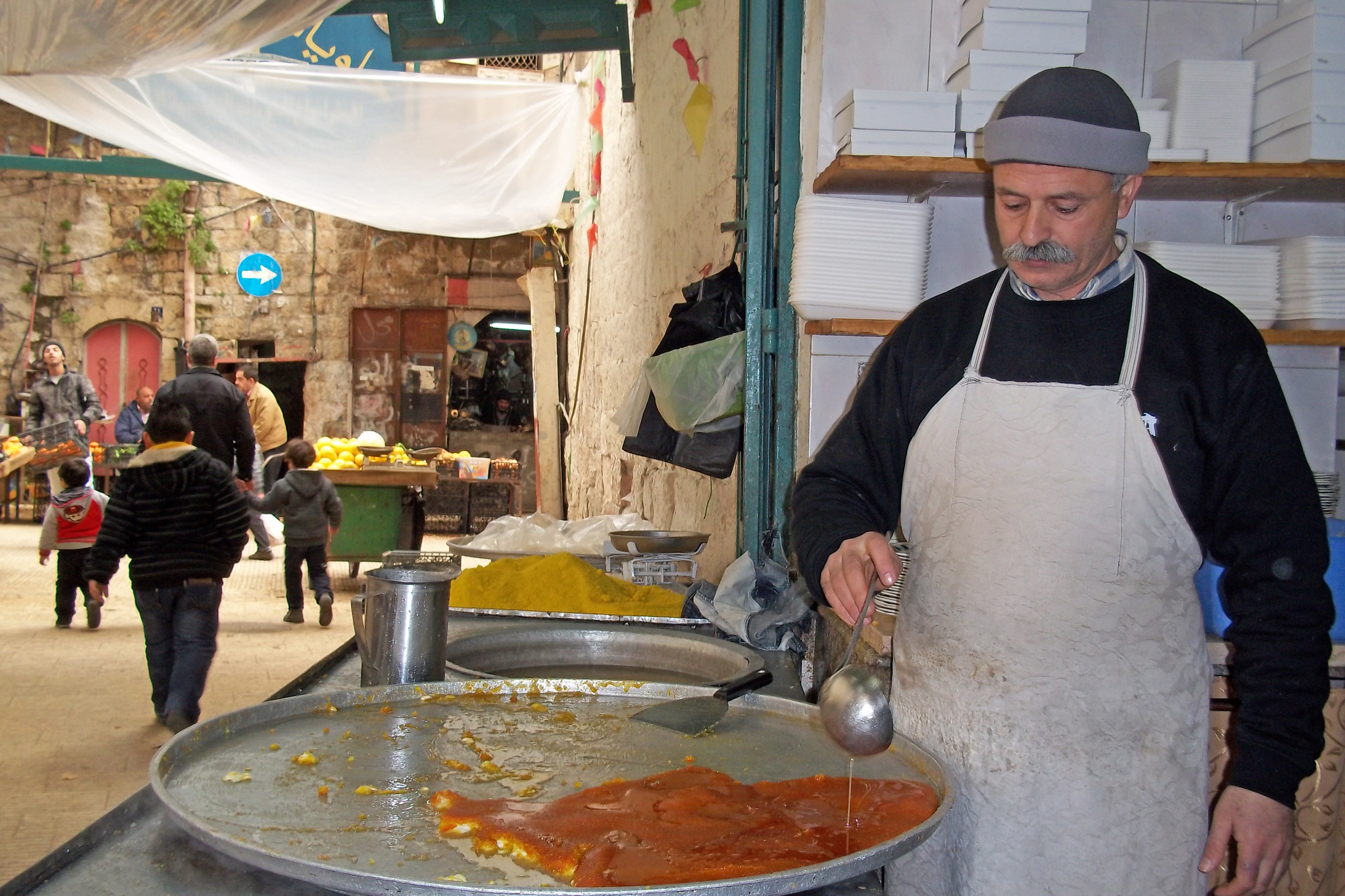 Kanafeh’ vendor from Arafat sweet shop in the Old City of Nablus. Despite some economic growth reported in the West Bank in 2011, purchasing power remains low