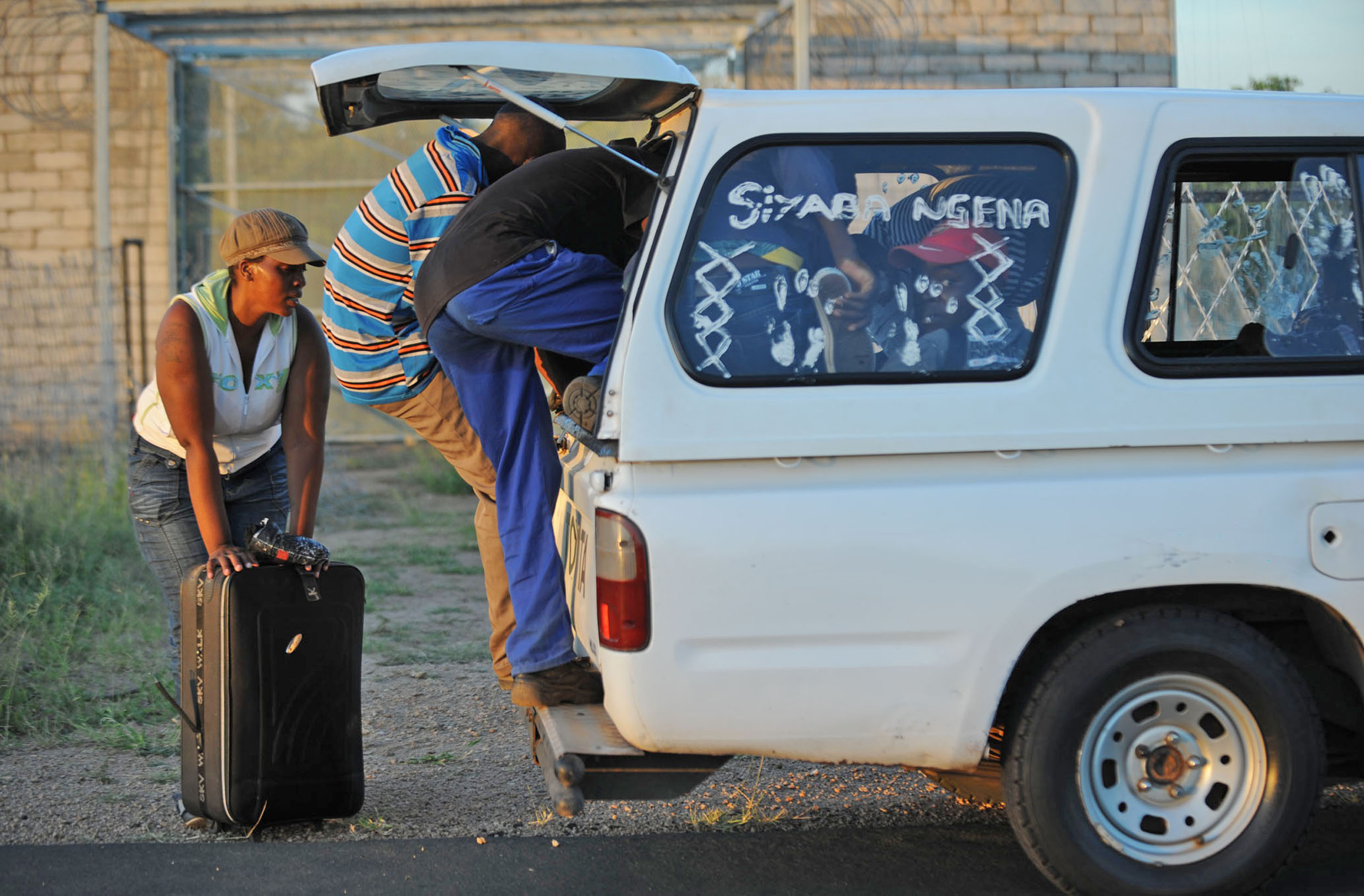 After jumping the border between Zimbabwe and South Africa, illegal migrants climb into a waiting vehicle that will transport them to the nearby town of Musina
