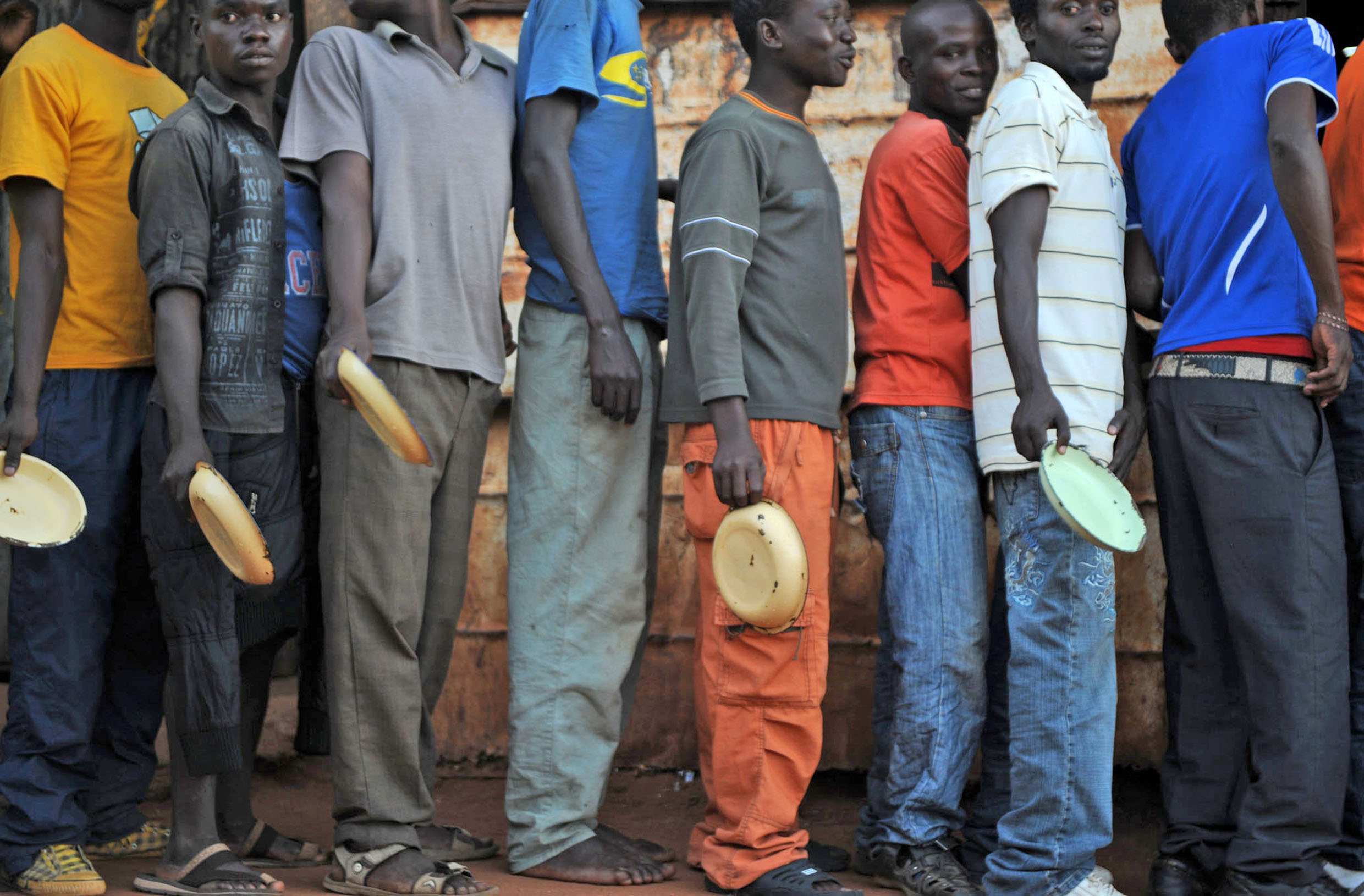 Migrants and asylum seekers at the ‘I believe in Jesus Church’ shelter for men in the South African border town of Musina queue up for a free hot meal, provided by the UN’s Refugee Agency (UNHCR)