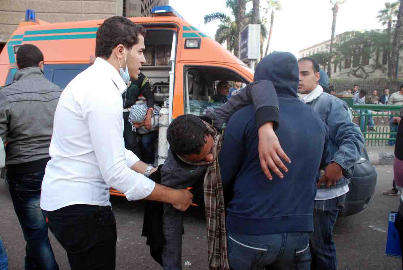 Volunteers help aid responders save victims of recent clashes between policemen and demonstrators in Cairo