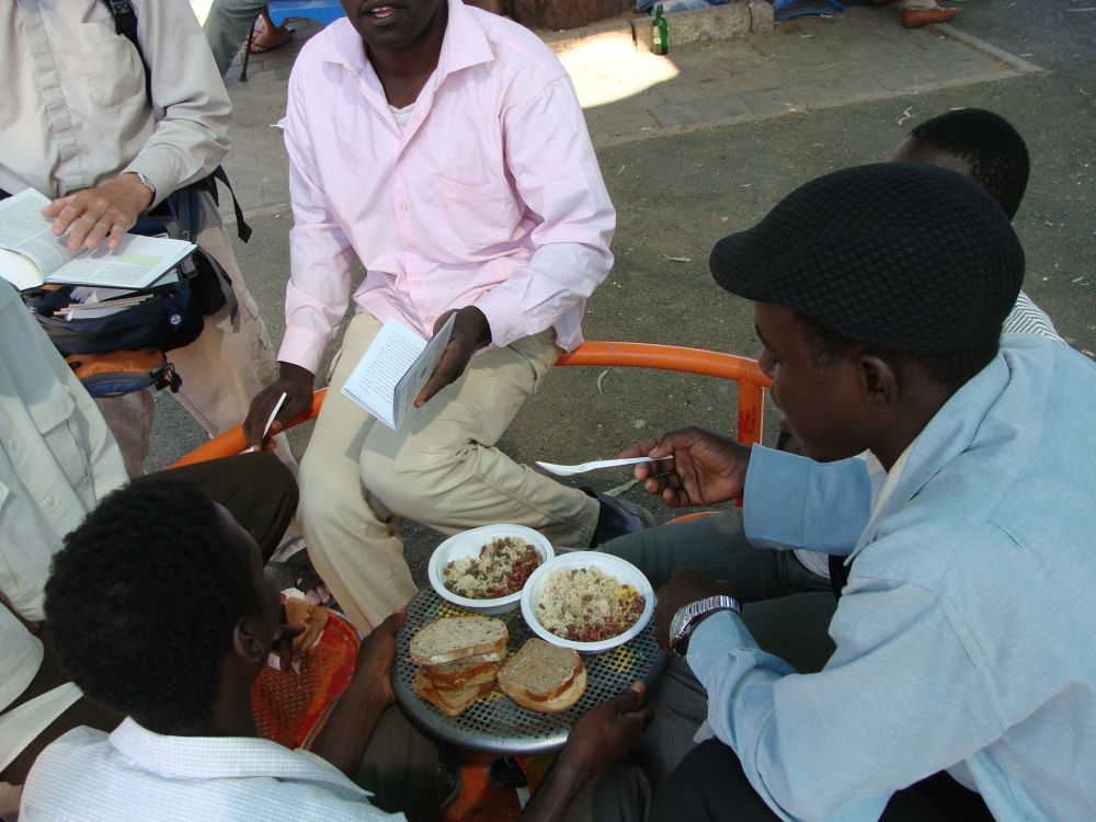 African migrants eating in a park in Tel Aviv