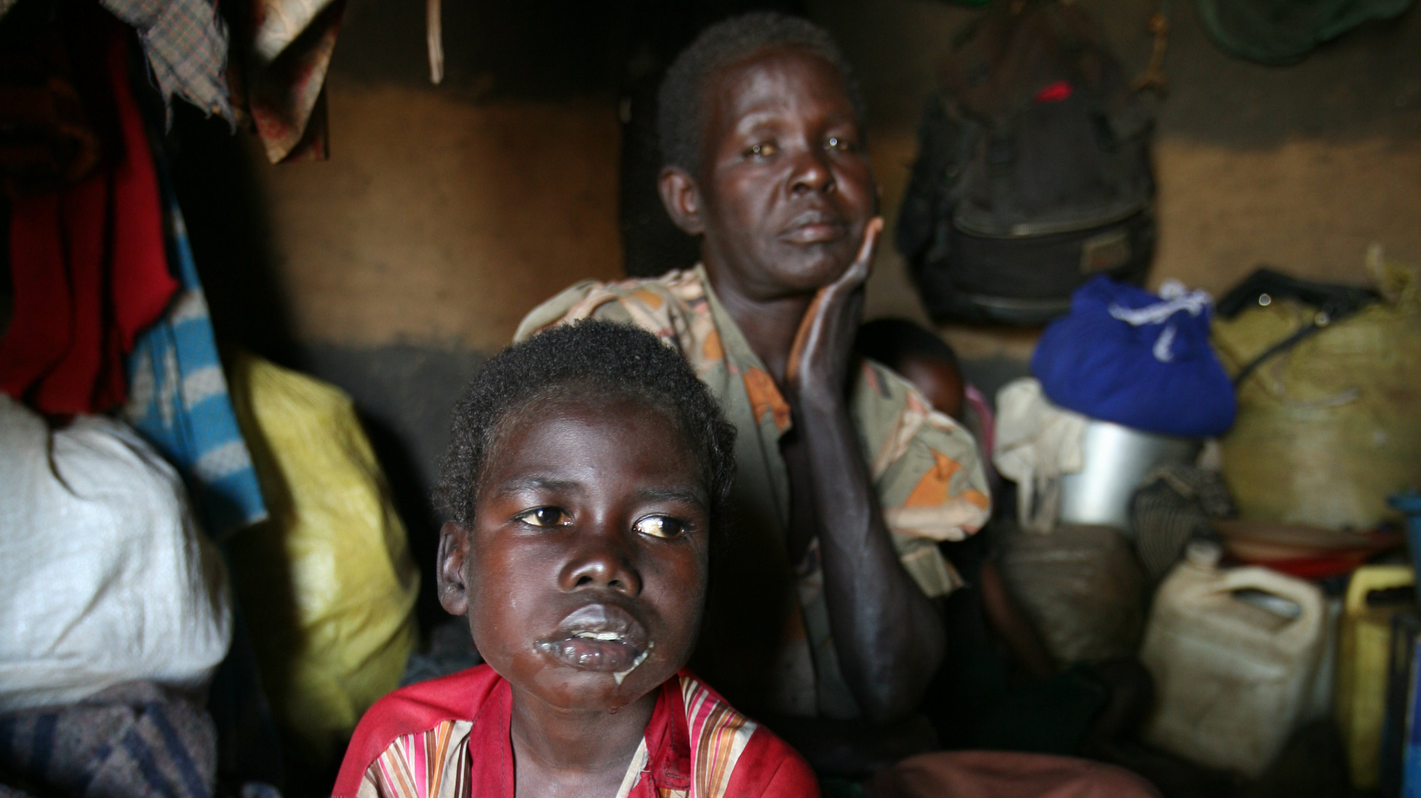 Grandmother seated with the grandchild suffering from Nodding disease