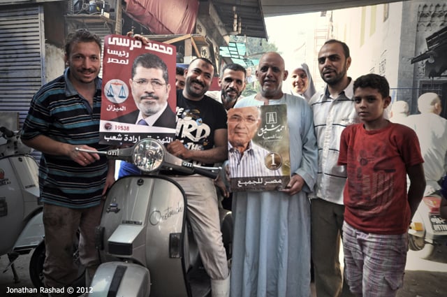 Egyptian voters holding up posters of the two presedential candidates in Cairo on June 16 2012