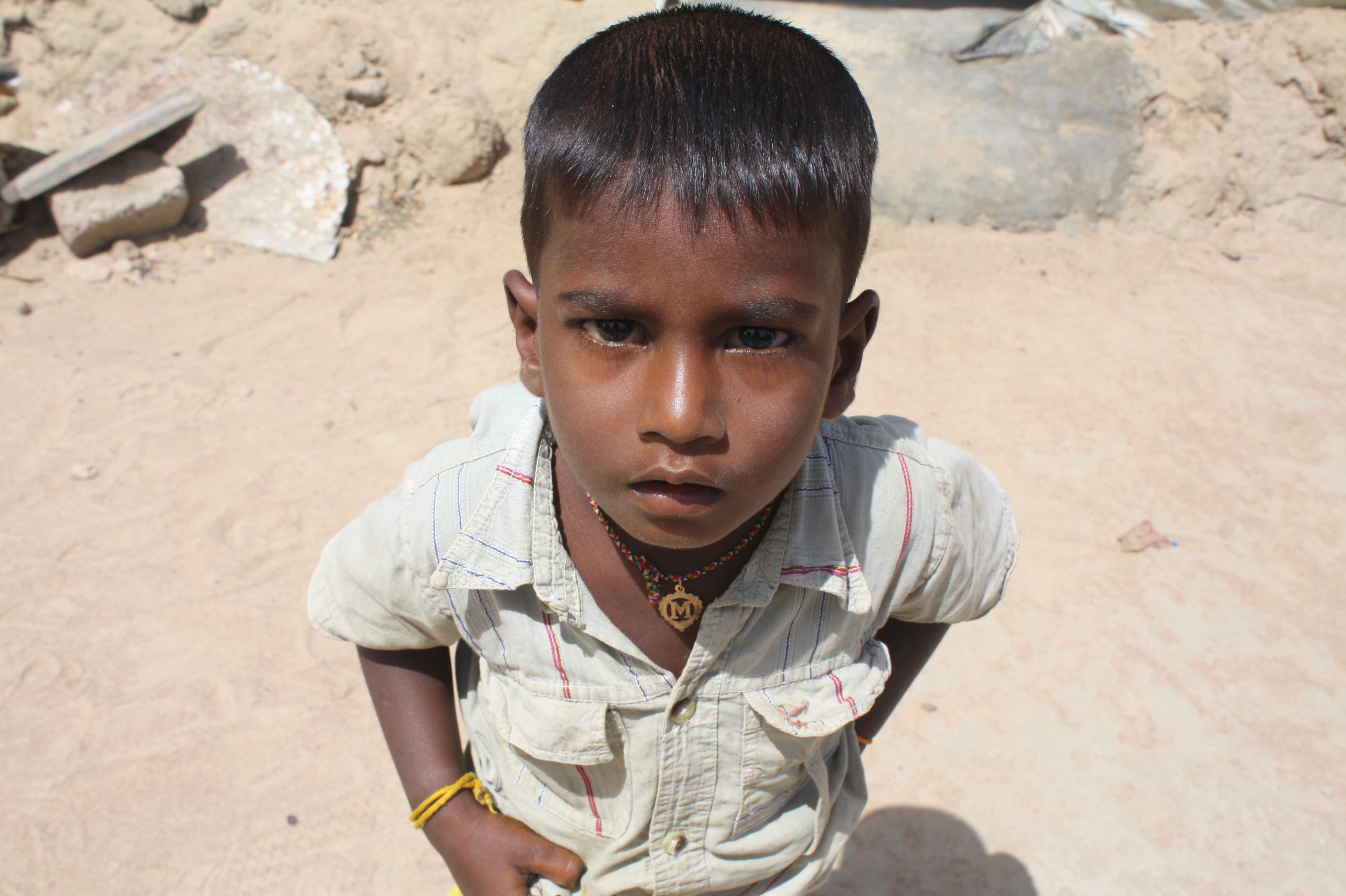 A young boy looks to the camera in the village of Malayalapuram outside Kilinochchi. Thousands of conflict-displaced have returned to the area since the end of Sri Lanka's decades-long war which ended in May 2009