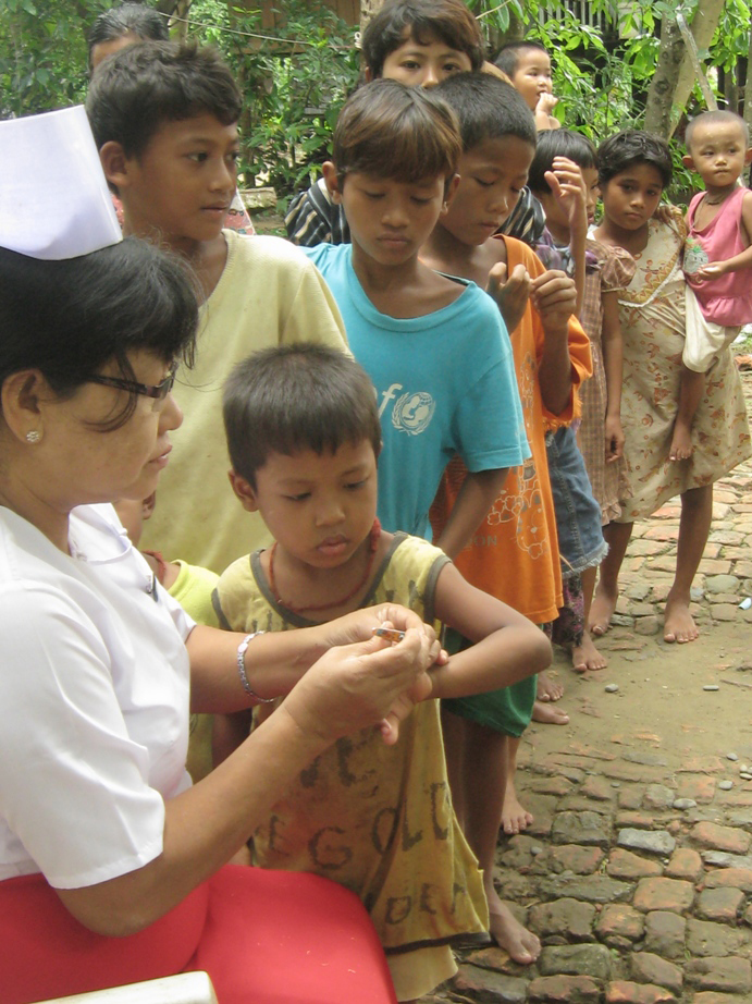 A nurse cuts the nails of children displaced by communal fighting in northern Rakhine State in June 2012. Thousands of people were displaced in the unrest