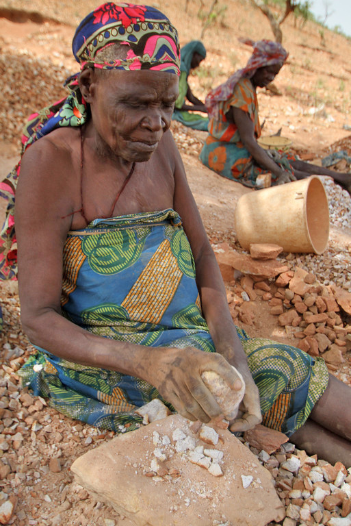 Older women in the Koloma IDP camp in Goz Beida, Eastern Chad, break rocks to make gravel, which sells at $3 a bag