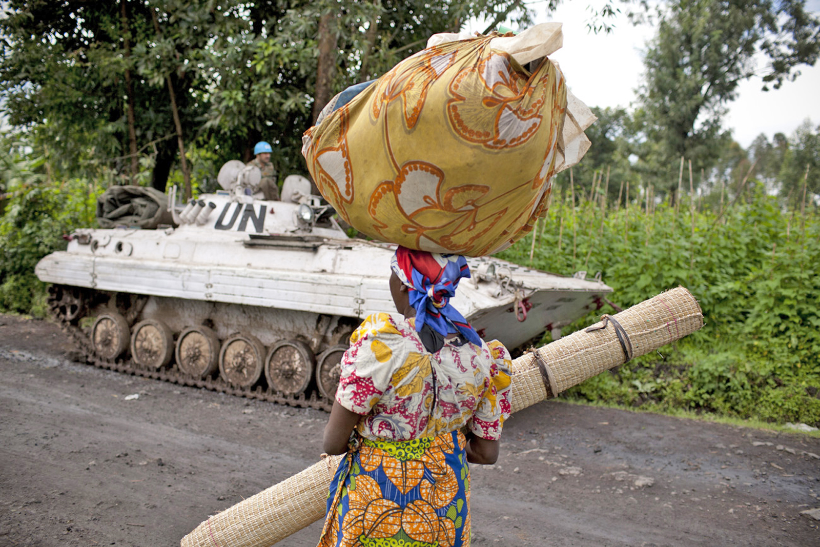 A Congolese woman walks past a UN peacekeepers’ base near Bunagana, eastern DRC (May 2012)