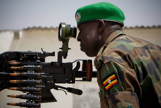 A Ugandan officer serving with the African Union Mission in Somalia (AMISOM) ranges a scope on a heavy machine-gun mounted on the roof of Mogadishu University 23 January. AMSIOM and Somali National Army (SNA) forces have consolidated newly captured positi
