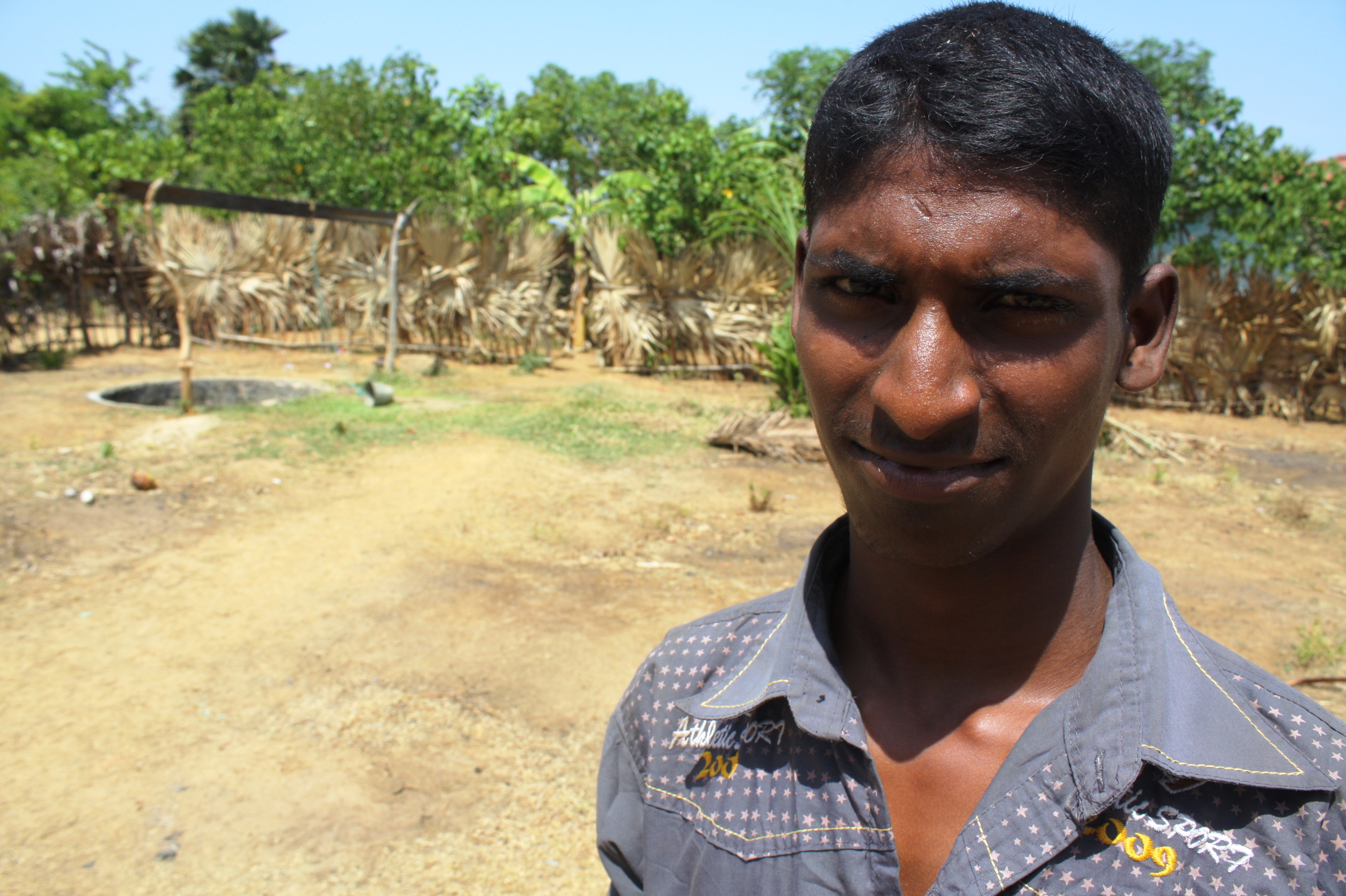 A young man looks to the camera in Jaffna, northern Sri Lanka. Unemployment is rife amongst young people in the former conflict zone