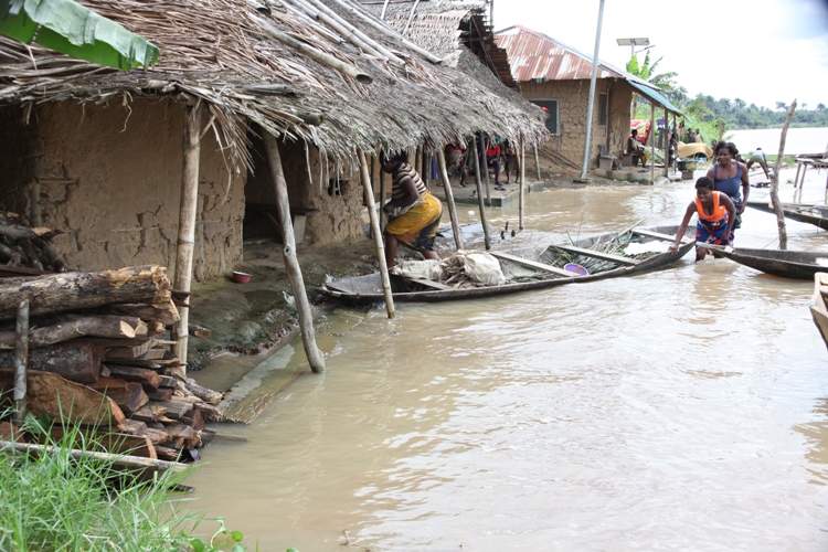Women with a dug-out canoe in front of their flooded homes in Toru-Orua in Sagbama local government area of Bayelsa state , September 2012. The National Emergency Management Agency, NEMA, estimates 1.3 million Nigerians were displaced by floods this year,