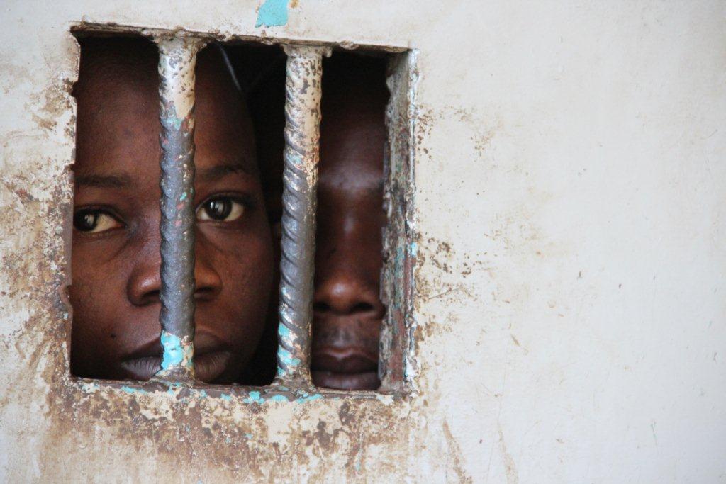 Juveniles in a police cell in a Sierra Leone, where women are being detained for owing debt