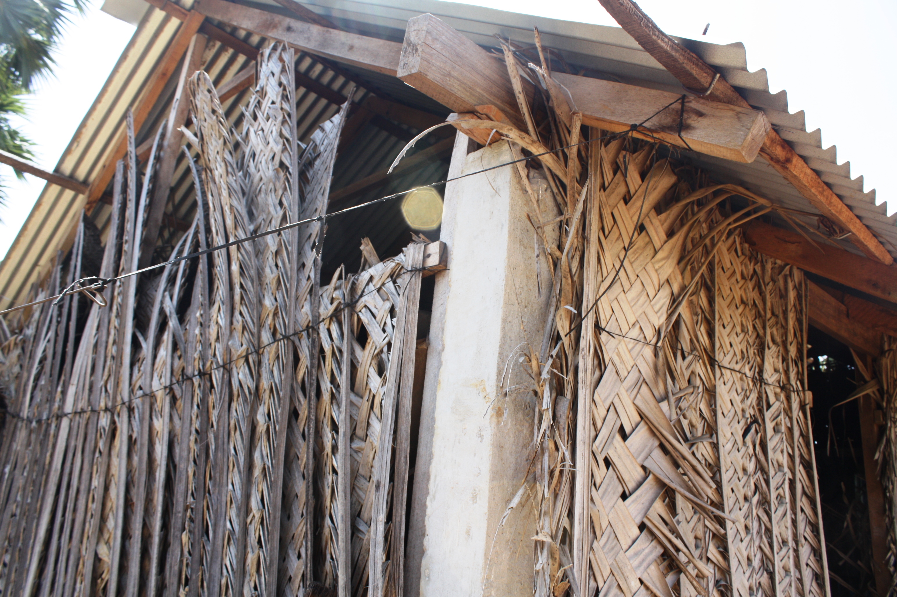 A three-year-old transitional shelter in Jaffna District. The coconut leaf matting used for its walls needs replacing