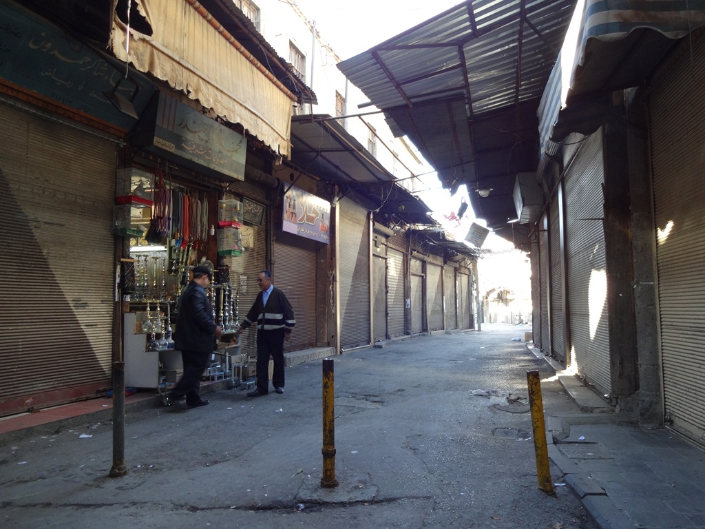 A lone shopkeeper stays open in the Old Souq of Damascus, the Syrian capital. Most shopkeepers close on Fridays, but as conflict, unemployment and rising prices have driven away customers, this man is desperate for a sale