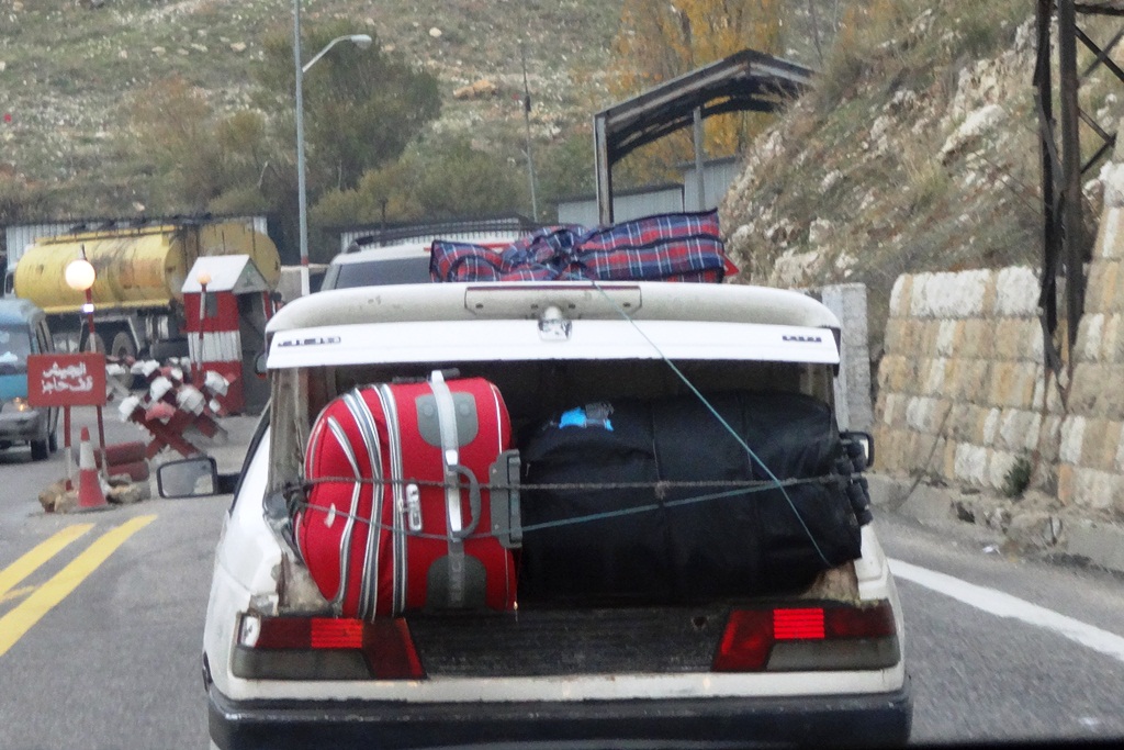 A car with a Syrian license plate crosses the border from Syria to Lebanon in the midst of an ever-worsening civil war