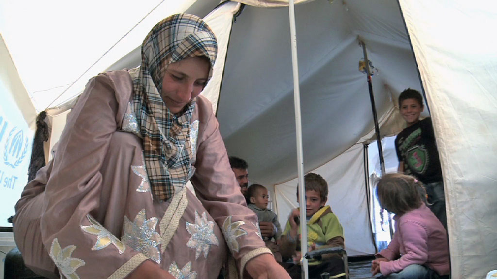 A Syrian refugee family shares a tent in Jordan