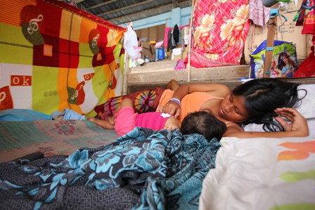 A young mother nurses her child at a shelter in Mindanao, which was badly affected by Typhoon Bopha in December 2012. More than 6.2 million people were affected