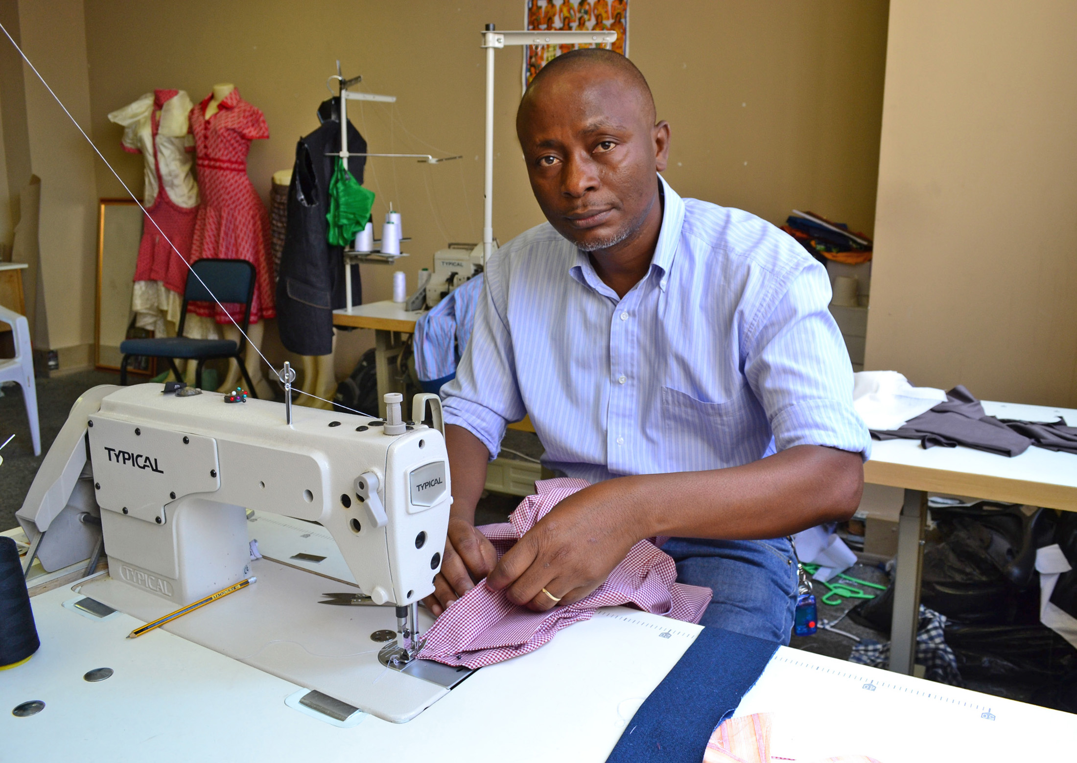 With business skills training and a grant from Jesuit Refugee Service, Clement Mukengeshay, a refugee from the Democratic Republic of Congo, has started a dressmaking business in inner-city Johannesburg
