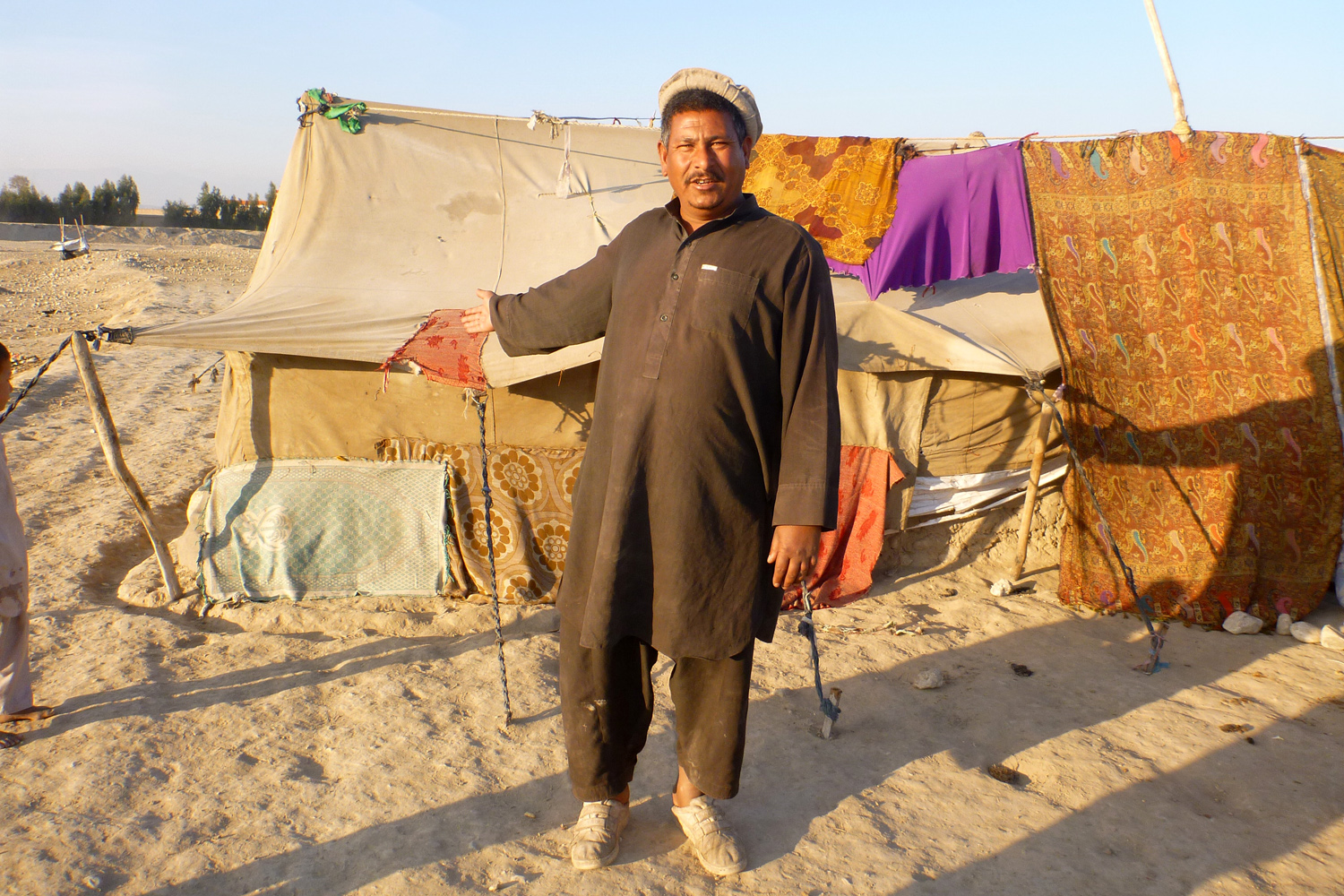 An internally displaced person (IDP) shows his living conditions on the outskirts of Jalalabad, Afghanistan (Jan 2013)