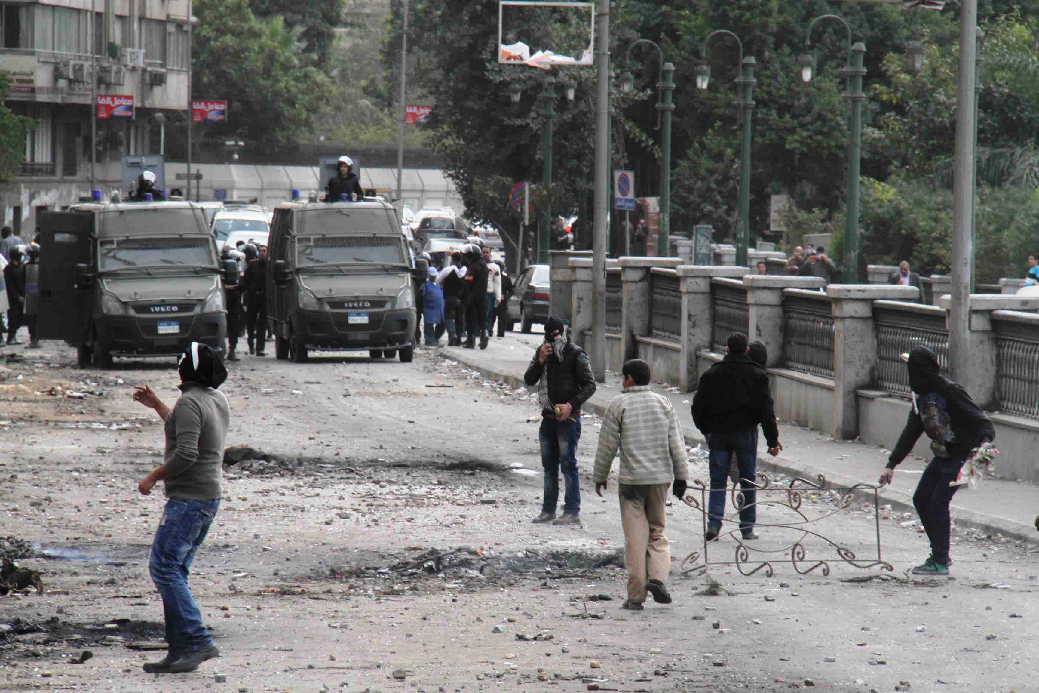 Angry protestors pelt policemen with stones in central Cairo on the second anniversary of the 2011 revolution that ousted long-time President Hosni Mubarak from power