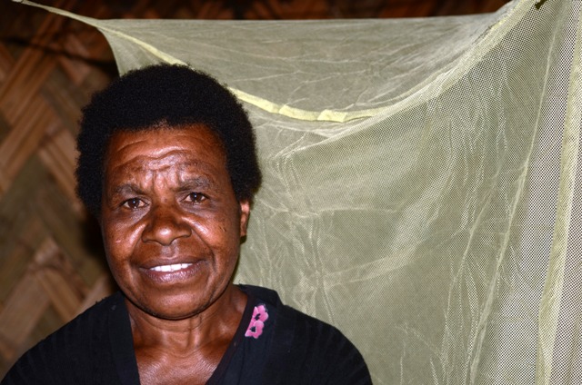 Susan Kake, 45, inside her hut in Masumave, a village of 2,000 largely subsistence farmers in PNG’s remote Eastern Highlands Province, rarely sleeps under the bednet behind her. Malaria remains endemic in the country