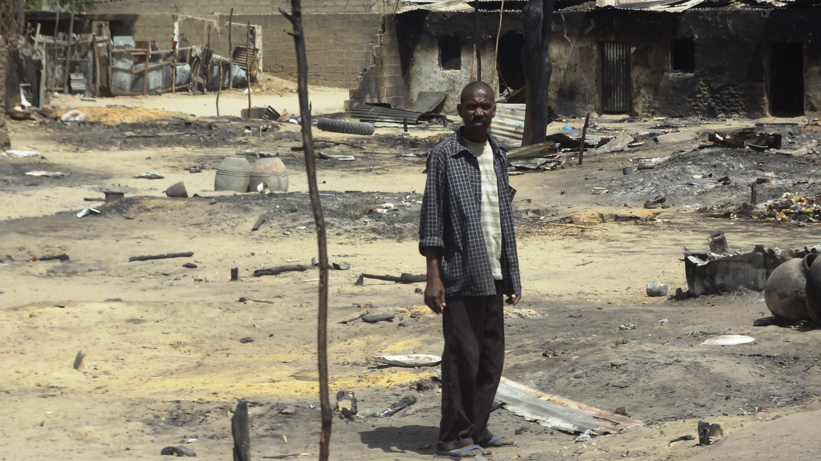 A man stands outside his destroyed home in Baga, Borno State, northeastern Nigeria, following heavy fighting between military forces from Nigeria, Niger and Chad, and Boko Haram in which some 187 people are estimated to have died