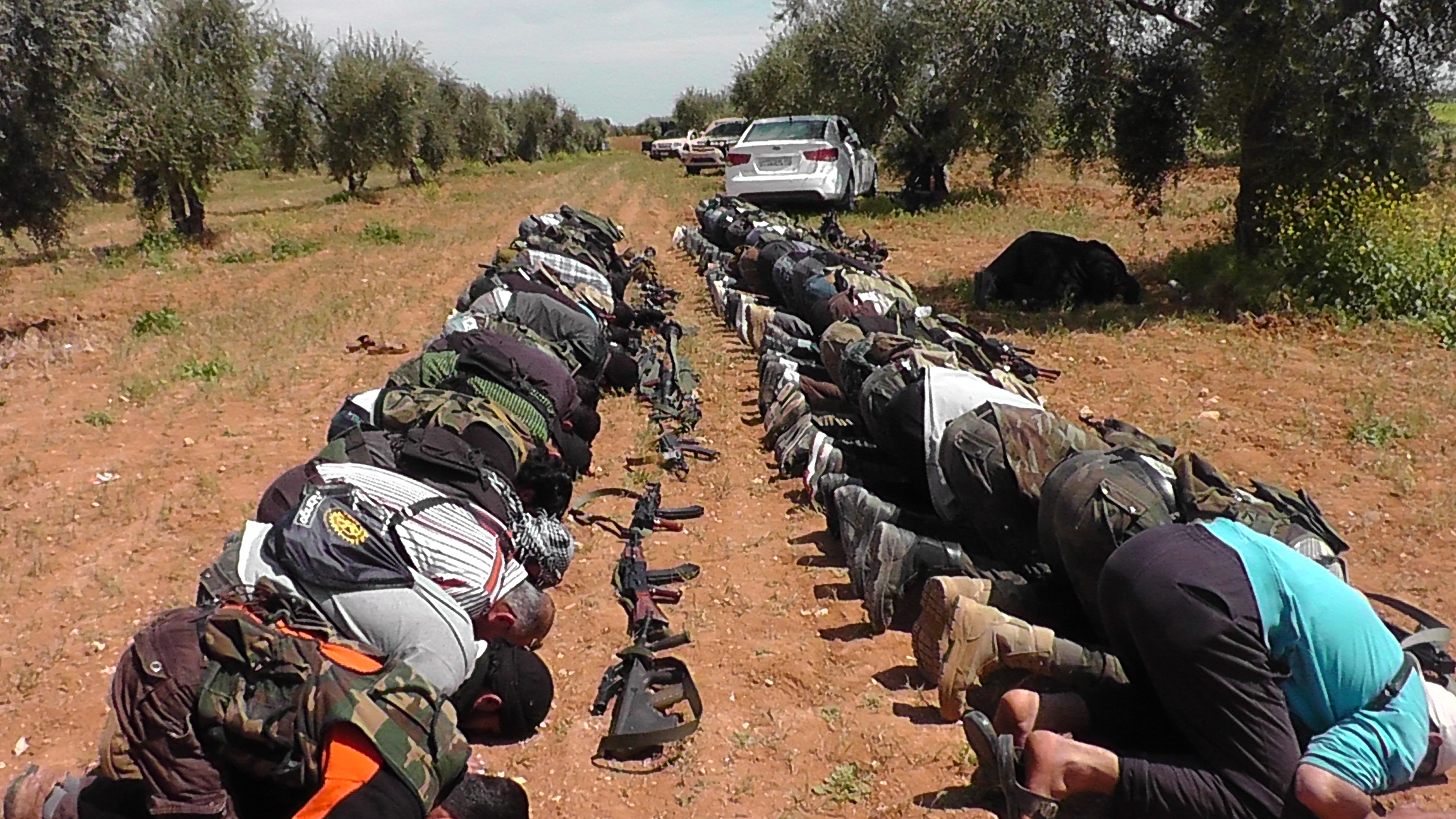 Rebel fighters of the religiously conservative Liwa al Fateh Brigade of the Free Syrian Army (FSA) put their guns down for prayer near the Menagh airbase in Aleppo governorate. Syrian rebels have used a mix of religion, international humanitarian law and