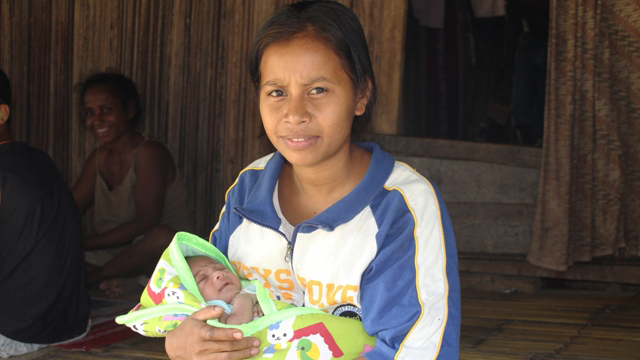 Teregina de Jesus Corterreal and baby son Juzia Mosquita de Jesus in Manufahi District, Timor-Leste 
