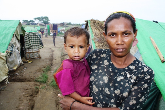 A Rohingya woman and her child look to the camera at a makeshift camp outside Sittwe in Myanmar's western Rakhine State in May 2013. An estimated 140,000 people were displaced following sectarian violence in 2012, the vast majority Rohingya Muslims