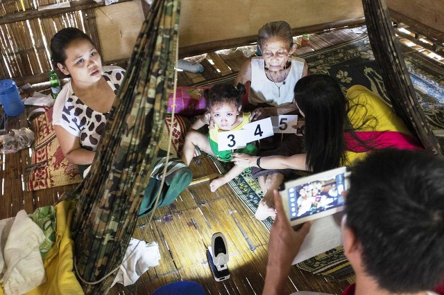 Mae Fah Luang Foundation staff verify individual biodata inside a household as part of the pilot refugee survey in Mae La camp undertaken in June 2013