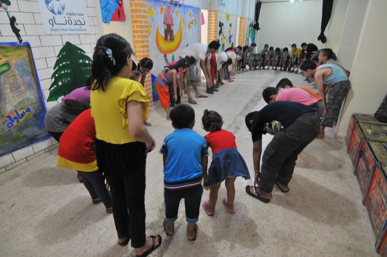 The NGO Najda Now helps children overcome trauma through art and theatre. Here, Najda's office in Lebanon works with refugee children from Syria and Palestine. They are stretching before class