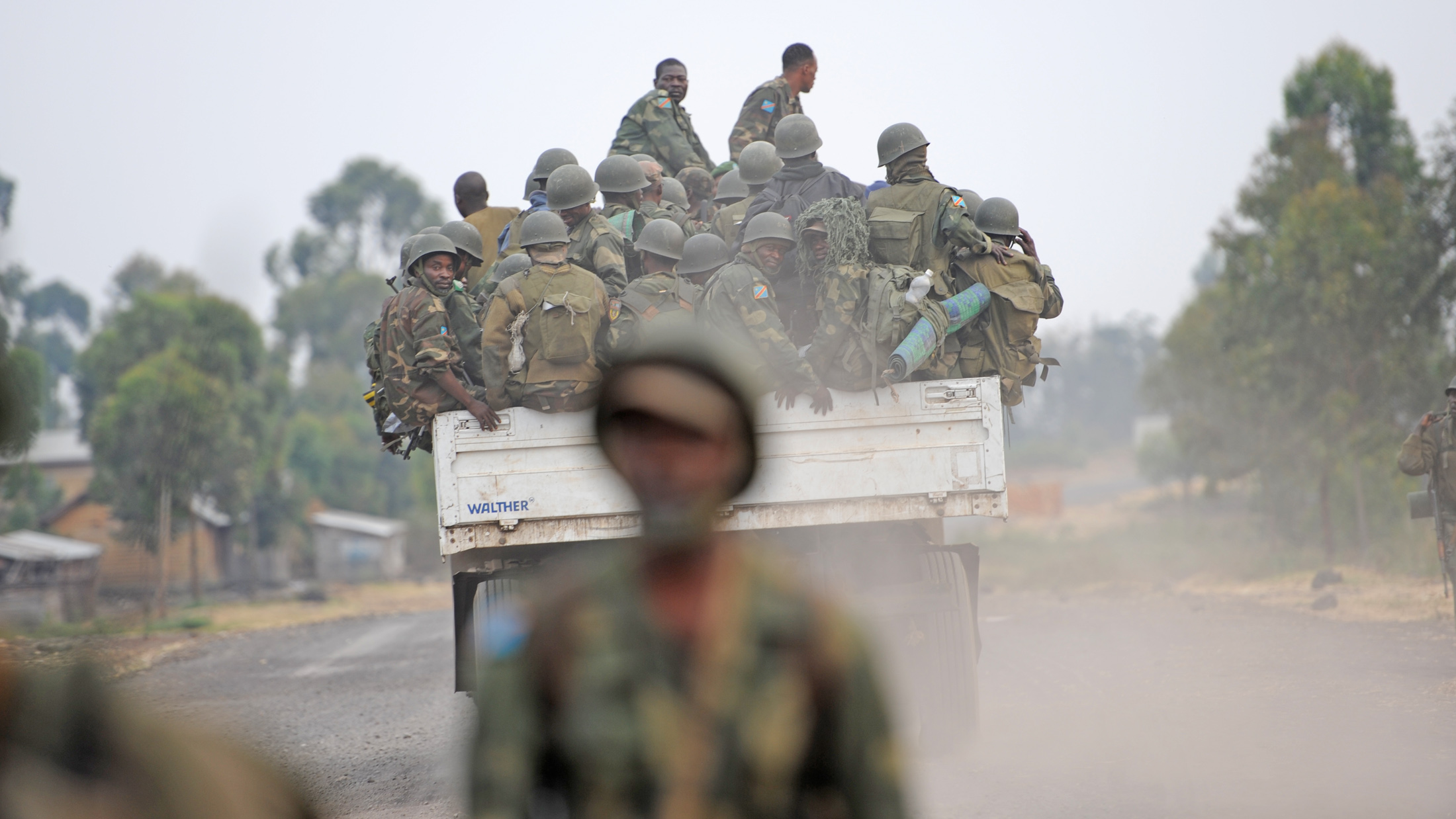 FARDC soldiers being transported on the back of a truck on the Kanyaruchinya frontline on the outskirts of theeastern DRC city of Goma