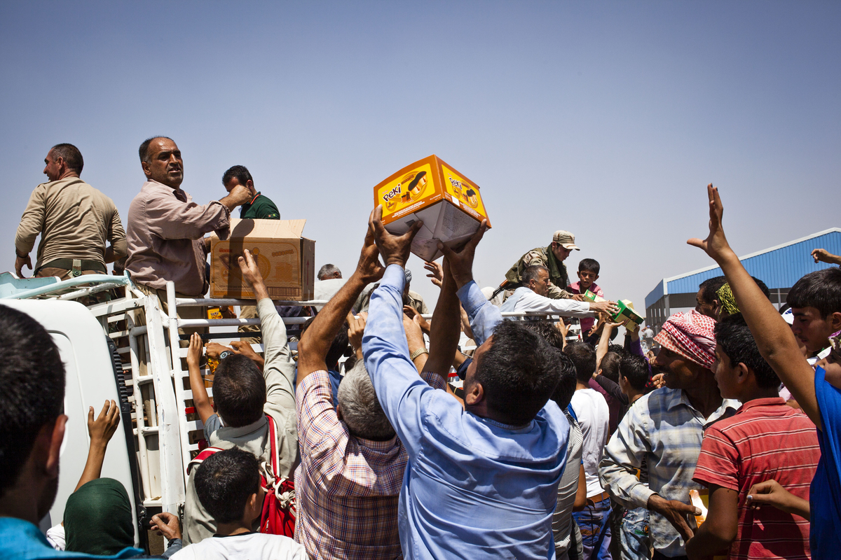 Syrian refugees, mostly Kurdish, recently arrived in the semi-autonomous region of Iraqi Kurdistan pictured at a reception and registration area near the town of Faysh Khabur. Aid was handed out at the reception area by the UN, Iraqi Kurdish authorities a
