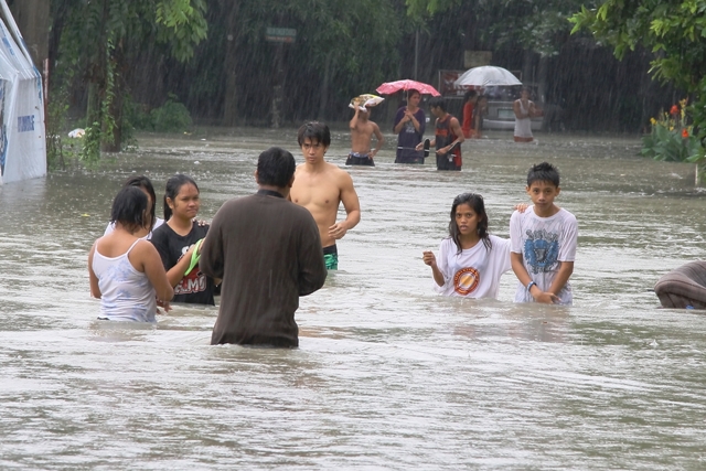 Kawit, Cavite -People wade in floods at the height of torrential rains on 18 August 2013