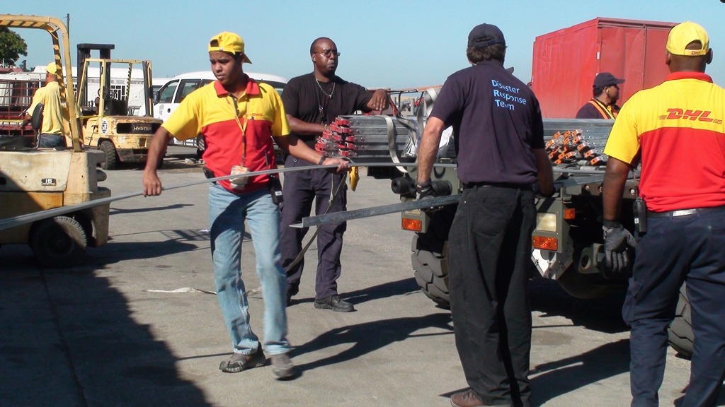 A Disaster Response Team, made up of 10 volunteers from from the courier company DHL, arrives at Toussaint L’ouverture International Airport in Port-au-Prince within 48 hours of the 2010 earthquake in Haiti to help organize incoming aid cargo. DHL says