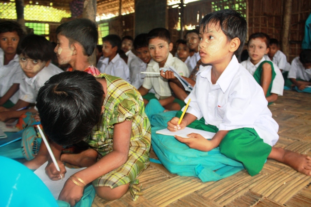Rohingya children receive emergency education through a community initiative at the Thea Chaung IDP camp outside Sittwe, western Rakhine State. More than 140,000 people were displaced following two deadly bouts of sectarian violence in 2012