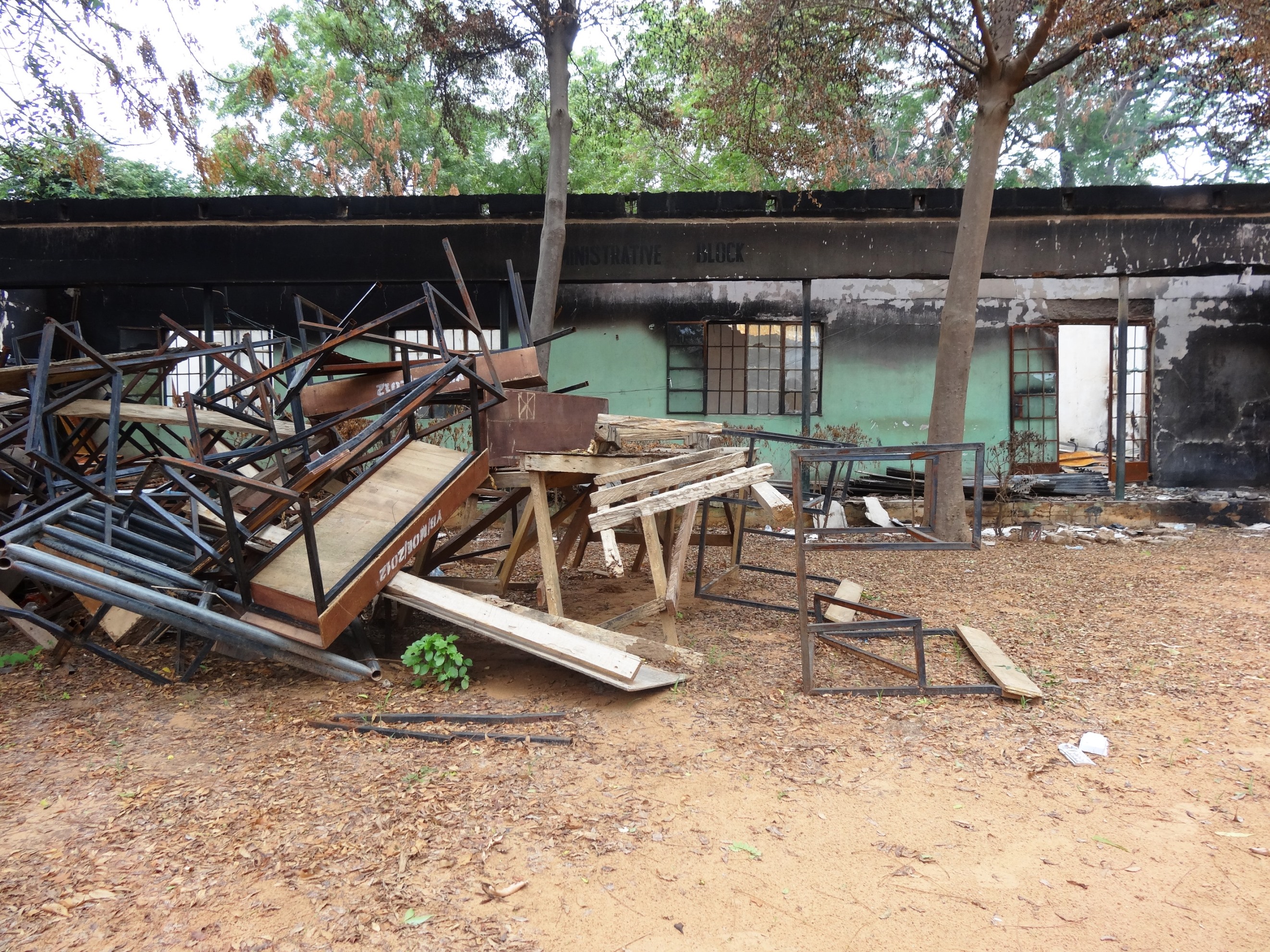 A heap of broken furniture outside burnt classrooms at a government secondary school Mamudo in Yobe state, northern Nigeria