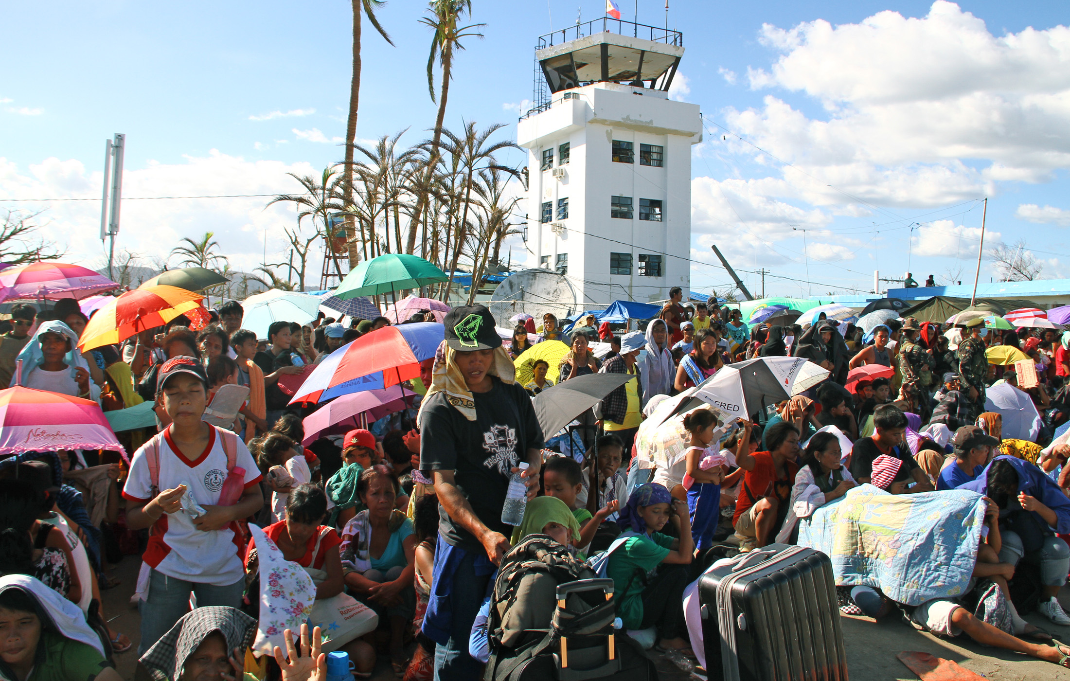 Residents gather outside the city's airport - a key regional transport hub - in a desperate bid to leave